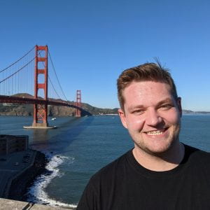 Student in t-shirt in front of Golden Gate Bridge